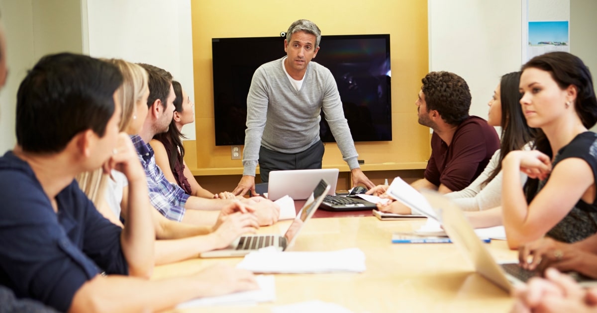 A corporate team engaged in a meeting, representing the dynamics of conflict resolution in director and shareholder disputes.